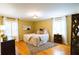 Sunlit bedroom featuring hardwood floors, a comfortable bed, and two windows with plantation shutters at 3548 Liberty Ln, Marietta, GA 30062