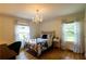 Bright bedroom with hardwood floors, chandelier, and windows with natural light at 3548 Liberty Ln, Marietta, GA 30062