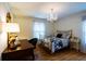 Charming bedroom features a decorative chandelier, hardwood floors, and lots of natural light at 3548 Liberty Ln, Marietta, GA 30062