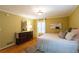 Bedroom with hardwood floors, a large dresser, window, and a comfortable bed with stylish pillows at 3548 Liberty Ln, Marietta, GA 30062
