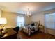 Bright bedroom featuring a chandelier, desk area, and windows that let in natural light at 3548 Liberty Ln, Marietta, GA 30062