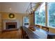 Bright dining area with dark wood table, fireplace, and large window with wooded views at 3548 Liberty Ln, Marietta, GA 30062