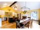 Spacious dining room with bright yellow walls, fire place, and modern chandelier at 3548 Liberty Ln, Marietta, GA 30062