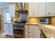 Modern kitchen features stainless steel appliances, granite countertops and white cabinetry at 3548 Liberty Ln, Marietta, GA 30062