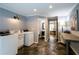 Well-lit laundry room featuring a utility sink, modern washer and dryer, and ample counter space at 3548 Liberty Ln, Marietta, GA 30062