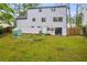 A view of the backyard with a garden area and a white two-story house at 6338 Boyett Dr, Norcross, GA 30093