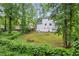 The backyard of the property features lush greenery, a small garden, and a two-story home at 6338 Boyett Dr, Norcross, GA 30093