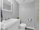 This is a clean white bathroom featuring a sink, mirror, and toilet at 6338 Boyett Dr, Norcross, GA 30093