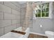 Tiled tub with shower showcasing contemporary design and a bright window view at 6338 Boyett Dr, Norcross, GA 30093