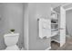 Bright bathroom with a toilet, towel rack, and shelving, offering essential amenities and organization at 6338 Boyett Dr, Norcross, GA 30093