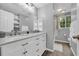 Well-lit bathroom with a double vanity, framed mirror, and white cabinets, offering ample storage at 6338 Boyett Dr, Norcross, GA 30093