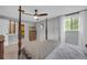 Spacious bedroom featuring a four-post bed, ceiling fan, and natural light from the window at 6338 Boyett Dr, Norcross, GA 30093
