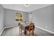 Sunlit dining room featuring laminate floors, gray walls, and a large window with a backyard view at 6338 Boyett Dr, Norcross, GA 30093