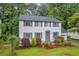 Beautiful two-story home boasts mature trees, manicured landscaping, and classic architectural design at 6338 Boyett Dr, Norcross, GA 30093