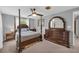 This is a bright gray main bedroom that features a king-size bed with dark-wood frame and carpeted floors at 6338 Boyett Dr, Norcross, GA 30093