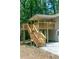 Exterior shot of a wooden deck with stairs leading to the backyard and red french doors at 6965 Kimberland Gardens Ln, Lithonia, GA 30058