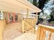 Wooden deck with stairs and railing provides a cozy spot with red double doors and backyard views at 6965 Kimberland Gardens Ln, Lithonia, GA 30058