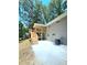 Exterior view of the new wooden deck and back of the home with a paved patio and backyard at 6965 Kimberland Gardens Ln, Lithonia, GA 30058