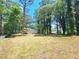 Expansive backyard with mature trees and a newly constructed deck create a serene and private oasis at 6965 Kimberland Gardens Ln, Lithonia, GA 30058