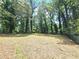The backyard features grassy areas and tall trees, offering a private and peaceful outdoor space at 6965 Kimberland Gardens Ln, Lithonia, GA 30058