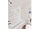 Clean, white tiled shower and tub combo featuring a recessed shower niche at 6965 Kimberland Gardens Ln, Lithonia, GA 30058