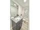 Small stylish bathroom featuring gray vanity and granite countertop at 6965 Kimberland Gardens Ln, Lithonia, GA 30058