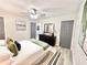 Comfortable bedroom with queen bed, modern gray accents, fan and neutral decor for a relaxing atmosphere at 6965 Kimberland Gardens Ln, Lithonia, GA 30058