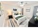 Well-lit bedroom featuring queen bed with modern decor, ceiling fan, and dark colored dresser at 6965 Kimberland Gardens Ln, Lithonia, GA 30058