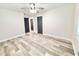 Spacious empty bedroom with ceiling fan, fresh paint, and wood-look flooring at 6965 Kimberland Gardens Ln, Lithonia, GA 30058