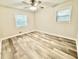 An empty bedroom features a ceiling fan, and wood-look flooring at 6965 Kimberland Gardens Ln, Lithonia, GA 30058
