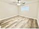 Bright, empty bedroom showcasing modern flooring and a ceiling fan at 6965 Kimberland Gardens Ln, Lithonia, GA 30058