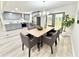 Bright dining area features stylish chandelier, seating for six, and access to backyard through double doors at 6965 Kimberland Gardens Ln, Lithonia, GA 30058