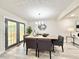 Cozy dining area with laminate flooring, a modern chandelier, and French doors leading to the outdoor space at 6965 Kimberland Gardens Ln, Lithonia, GA 30058