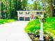 Inviting home exterior with well-manicured lawn, landscaped flower beds, and a classic mailbox at 6965 Kimberland Gardens Ln, Lithonia, GA 30058