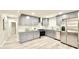 Updated kitchen with stainless steel appliances, gray cabinetry, granite countertops, and modern laminate flooring at 6965 Kimberland Gardens Ln, Lithonia, GA 30058