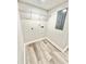 Functional laundry room with shelving and connections for washer and dryer at 6965 Kimberland Gardens Ln, Lithonia, GA 30058