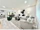 Open-concept living room with stylish furniture, modern decor, and laminate flooring, seamlessly connecting to dining area at 6965 Kimberland Gardens Ln, Lithonia, GA 30058