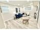 Open living area with a comfortable blue sofa, sleek coffee table, and plenty of natural light at 6965 Kimberland Gardens Ln, Lithonia, GA 30058