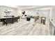 Spacious open-concept floorplan featuring a dining area, living room, and stylish laminate floors at 6965 Kimberland Gardens Ln, Lithonia, GA 30058