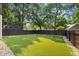 Landscaped backyard with fresh green lawn and dark wooden fence provides privacy and enhances outdoor living at 944 Herndon Nw St, Atlanta, GA 30318