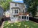 Backyard view showcases a two-story home with deck, sunroom, fenced yard, and freshly manicured lawn at 944 Herndon Nw St, Atlanta, GA 30318