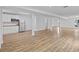 Open basement area with kitchenette, stainless refrigerator, and wood-look floors at 944 Herndon Nw St, Atlanta, GA 30318