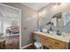 Bathroom features a wood vanity with dual sinks, granite countertop, and gray subway tile at 944 Herndon Nw St, Atlanta, GA 30318