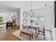 Elegant dining area features a stylish chandelier, a modern table, and views of the backyard at 944 Herndon Nw St, Atlanta, GA 30318