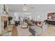 Spacious living room with stone fireplace, hardwood floors, and open floor plan to kitchen at 944 Herndon Nw St, Atlanta, GA 30318