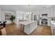 Bright and airy living space with a kitchen island, stainless appliances, and an open layout for comfortable living at 944 Herndon Nw St, Atlanta, GA 30318