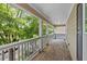 Spacious covered porch with wood floors, fresh air, and lovely views of the surrounding greenery at 944 Herndon Nw St, Atlanta, GA 30318