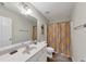 Bathroom with a single sink vanity, shower with curtain, and a door to a closet at 1936 Lakeshore Overlook Circle Nw Cir, Kennesaw, GA 30152