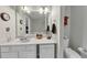 Well-lit bathroom featuring a white vanity with solid surface countertops, a large mirror, and toilet at 1936 Lakeshore Overlook Circle Nw Cir, Kennesaw, GA 30152