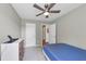 Neutrally decorated bedroom, featuring a bed, a modern ceiling fan, and plenty of natural light at 1936 Lakeshore Overlook Circle Nw Cir, Kennesaw, GA 30152